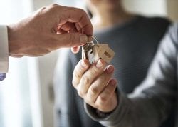handing over keys with a house key chain