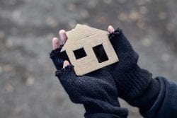fingerless gloves holding cardboard home