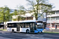 public transit bus driving down the road